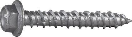 Metallisk betongskruv med sexkantigt huvud och fläns, liggande på en grå yta.
