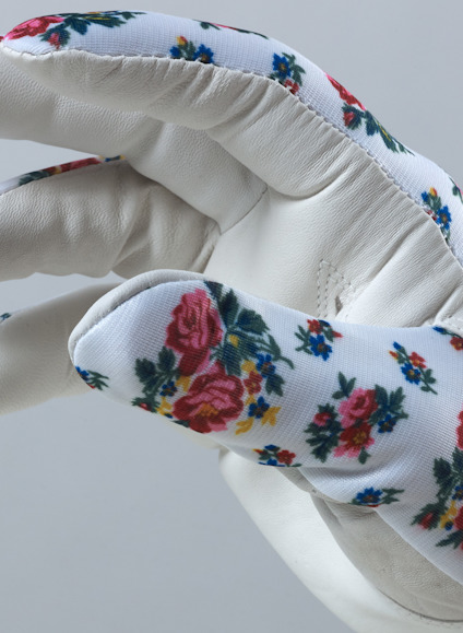 Vit handske med rosblommigt mönster på ovansidan.