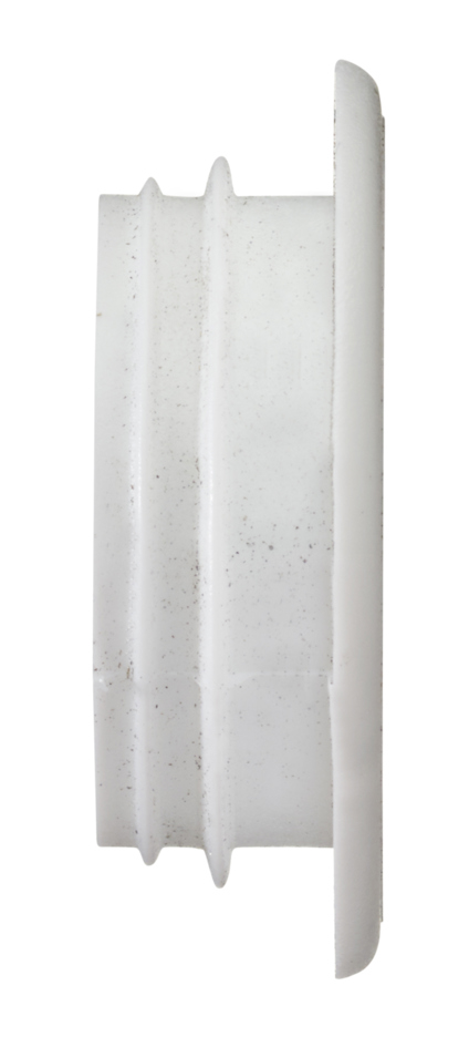 Vitt, rundat plastföremål med ribbad struktur och en platt kant.