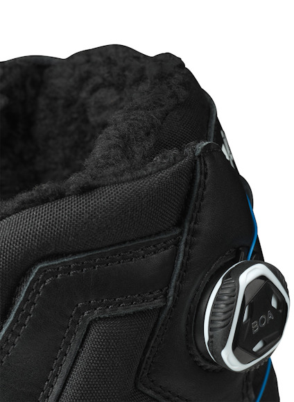 Svart känga med BOA-snörningssystem och vadderat innertyg i fuskpäls.