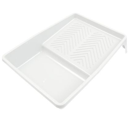 Ett vitt plasttråg med lutande yta och räfflat mönster på ena sidan.